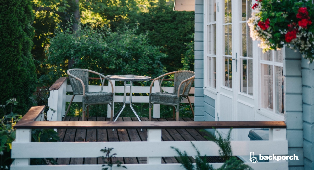 table and chairs on a shady backyard deck